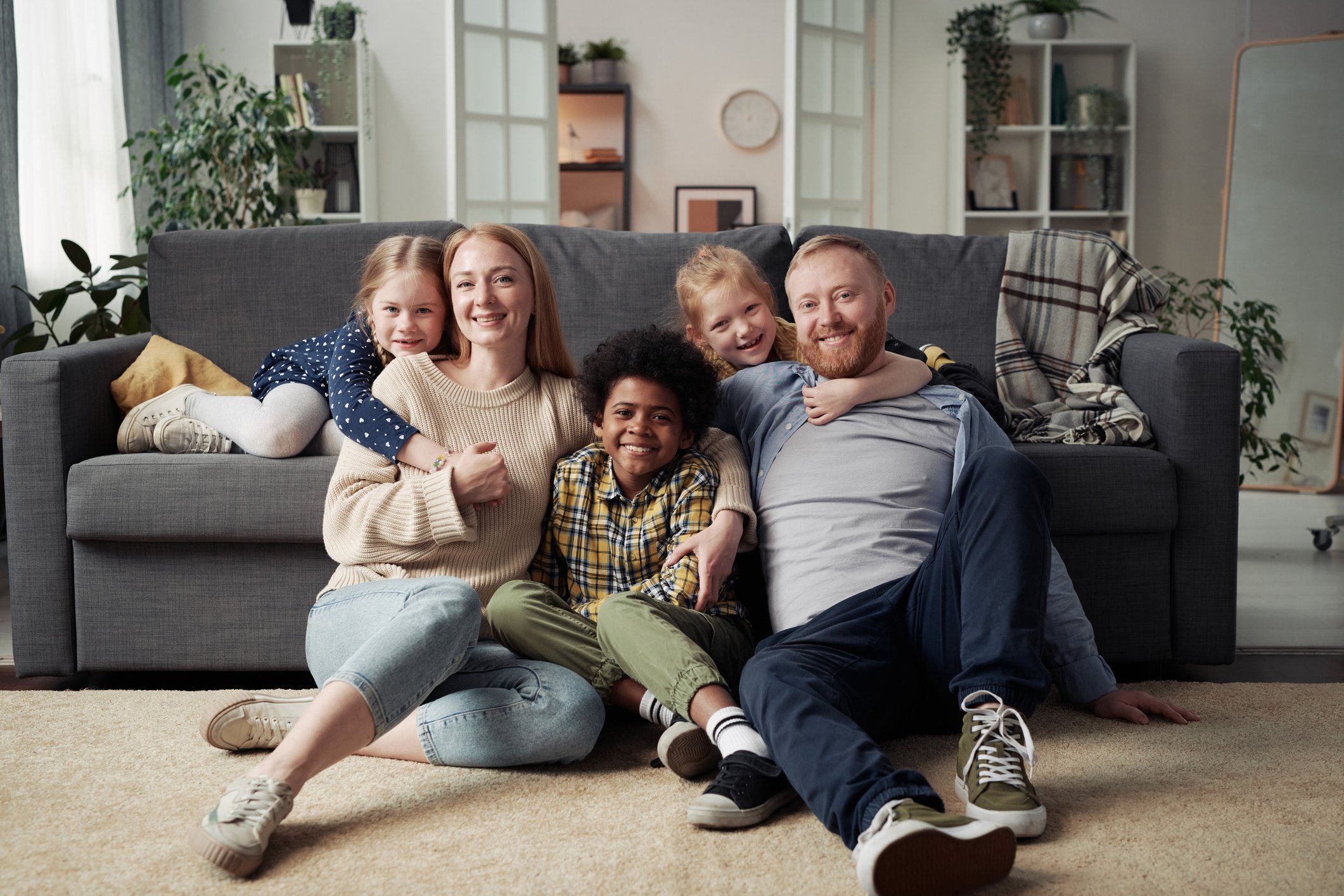 Foster children and their foster parent spending time together at home