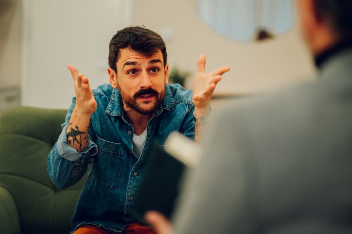 An angry client is expressing his feelings and explaining problems with a therapist