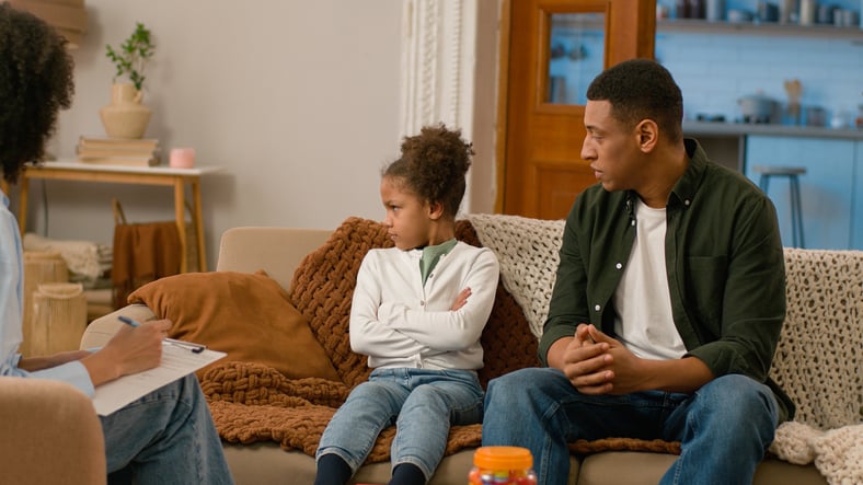 Young girl mad during family therapy.