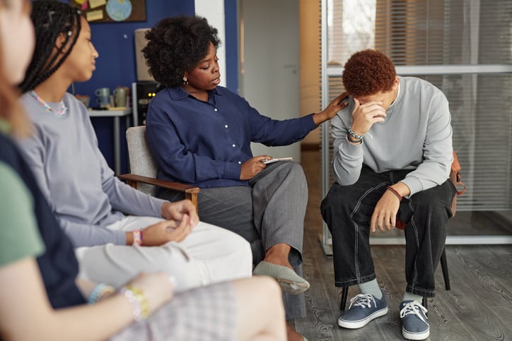 Group showing patience to a boy in therapy. 
