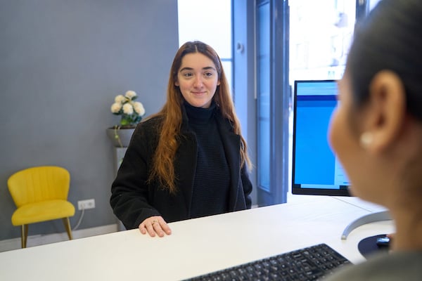 A clinic administrator greets a walk-in patient and is able to run a real-time patient eligibility check for insurance based on the patient information provided, reducing administrative burdens and improving patient satisfaction
