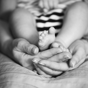  Photo of a baby and a caregiver, representing the use of EHR solutions tailored for social workers and those in human services, behavioral health, and social service agencies.