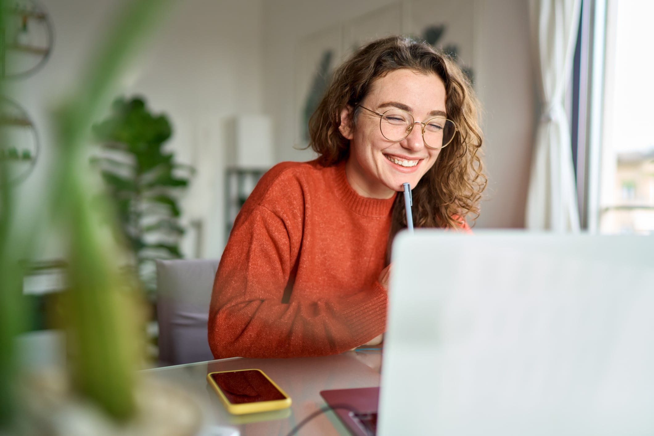 Image of a woman looking at a laptop and reviewing the EHR implementation timeline