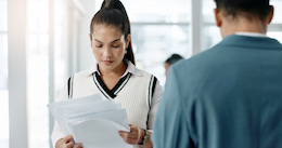 Female patient reading mental health intake form