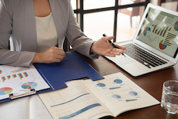 A woman working at a medical practice looks at the performance reports that were automatically generated from the practice's clinic management software